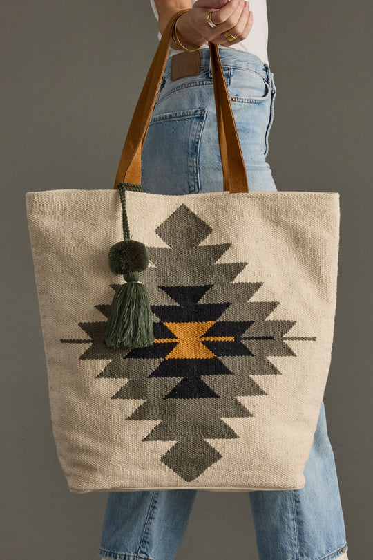 Tote bag with geometric pattern held by a person wearing jeans