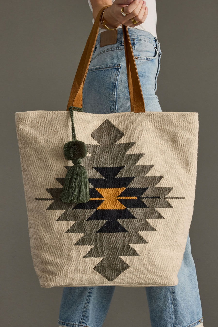Tote bag with geometric pattern held by a person wearing jeans