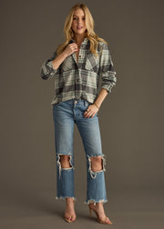 A woman poses against a plain gray background wearing the panacheaccessories Dakota Super Soft Button Up, paired with ripped blue jeans and nude high-heeled sandals.