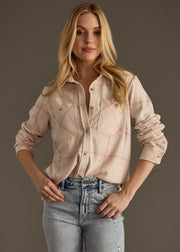 A woman with long blonde hair wears the panacheaccessories Blaire Super Soft Button Up and light blue jeans, standing against a plain background with one hand on her hip and a relaxed expression.