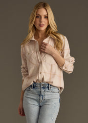 A woman with long blonde hair models the panacheaccessories Blaire Super Soft Button Up, paired with high-waisted light blue jeans, standing against a plain gray background and looking at the camera.