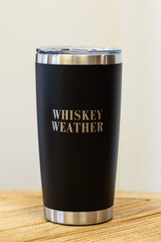 The 20oz Whiskey Weather Tumbler by Panache Apparel Collection features a sleek black design with bold silver lettering and a clear lid—perfect for stylishly enjoying your favorite drink.