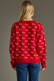 Person wearing a red sweater with 'ho ho ho' pattern on a gray background