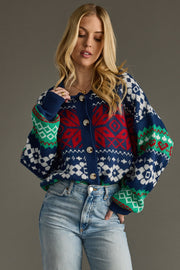 Woman wearing a colorful patterned sweater against a gray background