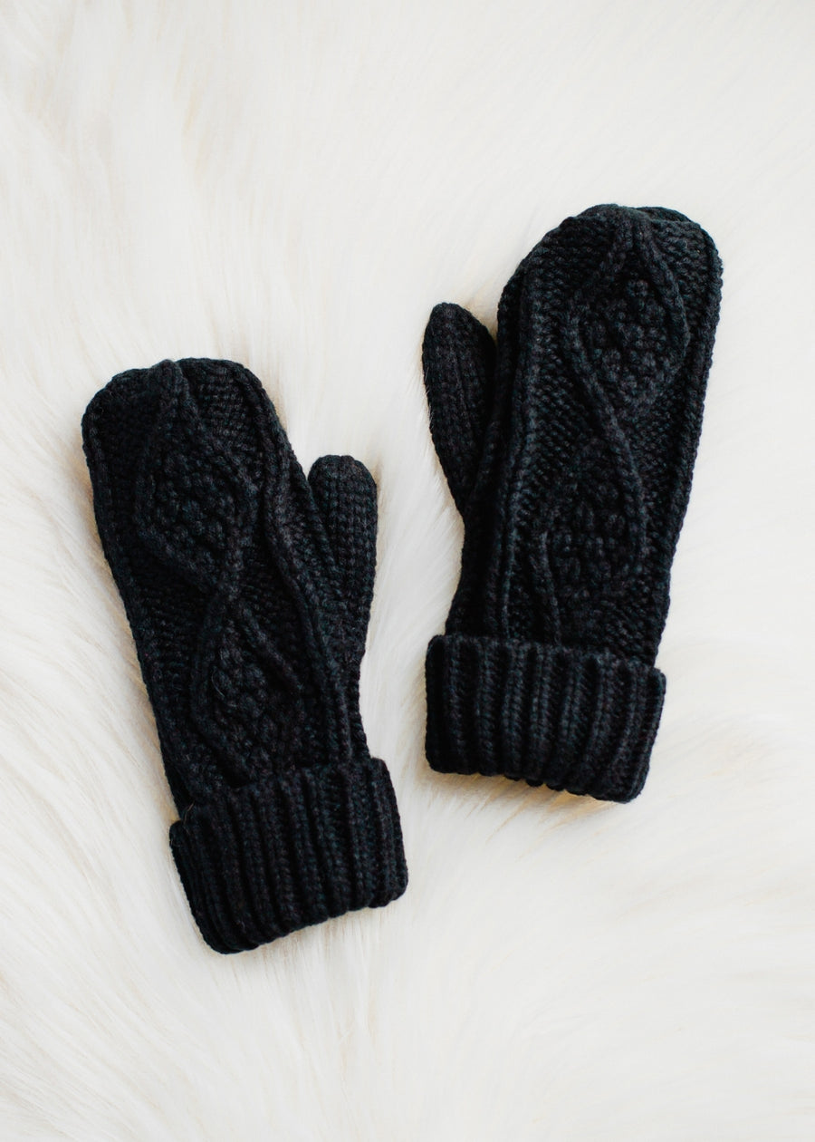 Pair of black knit mittens on a white background