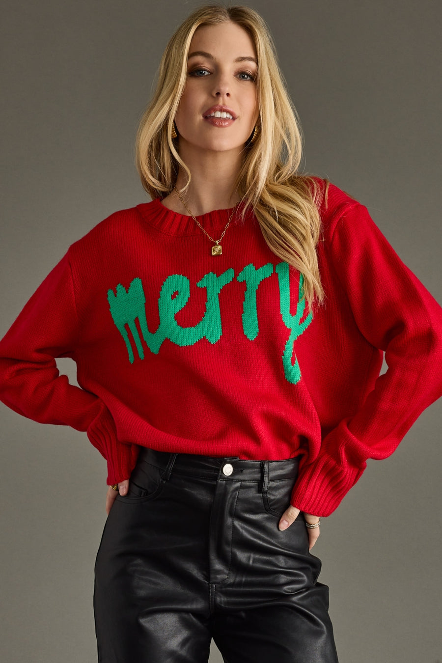 Person wearing a red sweater with green text on a gray background