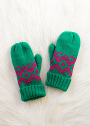 Pair of green mittens with pink patterns on a white textured background