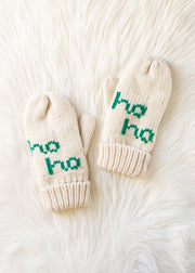 Pair of cream-colored mittens with 'ho ho' text on a white fur background