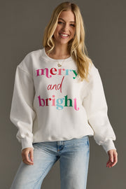 Woman wearing a white sweatshirt with colorful text on a gray background