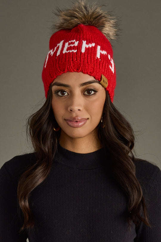 Woman wearing a red beanie with text against a gray background