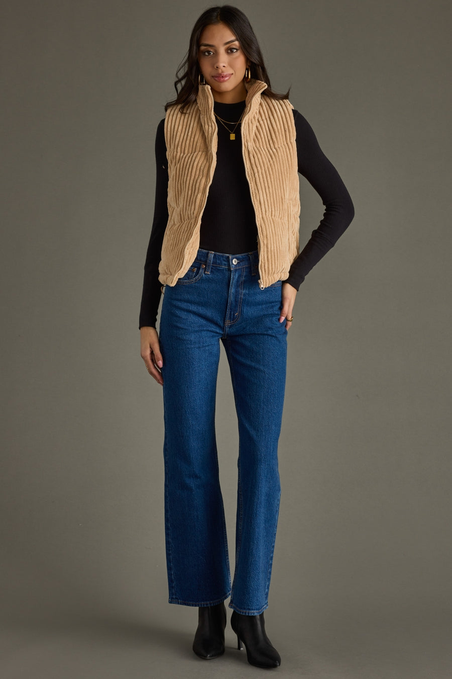 Woman styling the tan Taysha corduroy vest with jeans and casual boots.