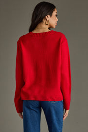 Person wearing a red sweater and blue jeans on a gray background