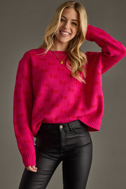 Woman wearing a bright pink sweater with red text against a gray background