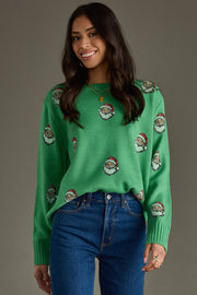 Woman wearing a green sweater with Santa Claus pattern against a gray background