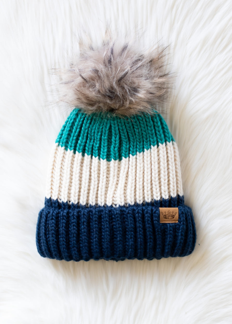 Knitted beanie with a pom-pom on a white background