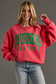 Person wearing a red sweatshirt with green text on a gray background