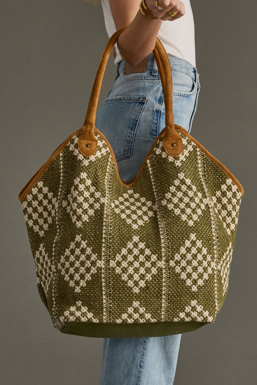 Close-up of Panache Apparel Collection’s olive and cream diamond pattern tote with tan shoulder straps.