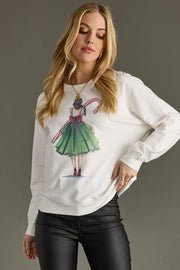 Woman wearing a white sweatshirt with a colorful graphic design on a gray background