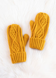 Pair of mustard yellow knitted mittens on a white background
