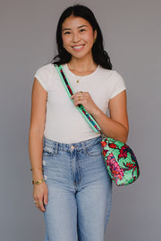 Woman holding a colorful bag against a gray background