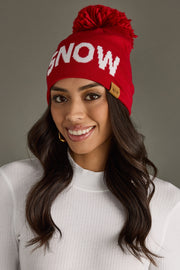 Woman wearing a red 'SNOW' beanie with a gray background