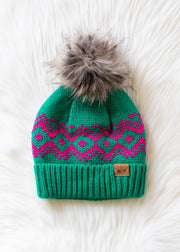 Green knit beanie with pink pattern and gray pom-pom on a white background