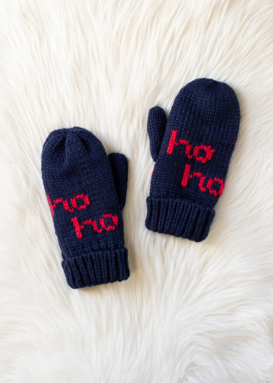 Pair of navy blue mittens with red text on a white fur background