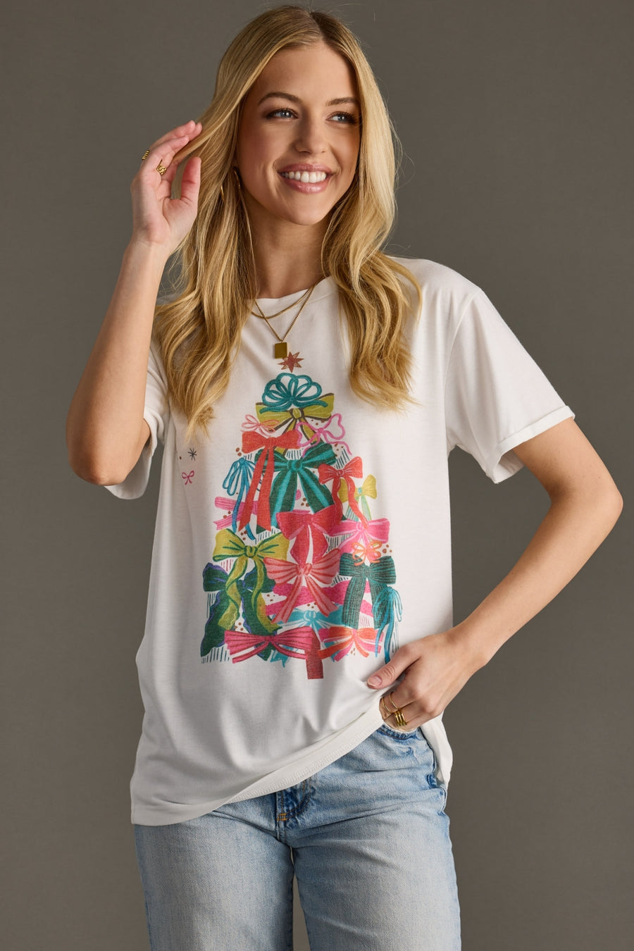 white graphic t-shirt with Christmas tree bow design on the front