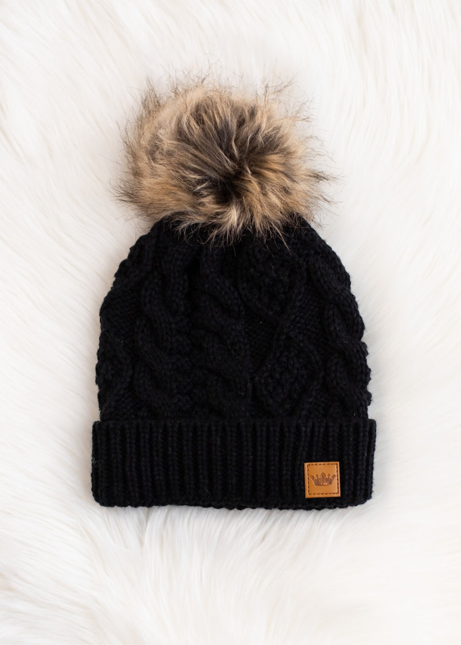 Black knit beanie with a fur pom-pom on a white background