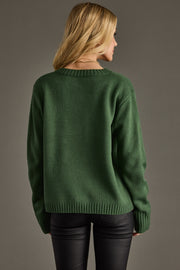 Person wearing a green sweater against a gray background