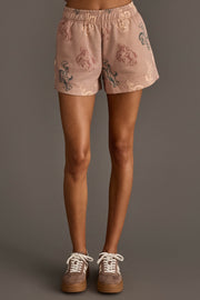Woman wearing Panache Apparel’s dusty rose western print lounge shorts.