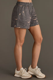 Woman wearing Panache Apparel’s gray western print lounge shorts.