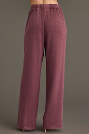 A person is shown from the waist down and viewed from the back, wearing Panache Apparel Collection’s Merlot Washed Soft Sweatpants. A loose-fitting, high-waisted style, in front of a plain gray background.