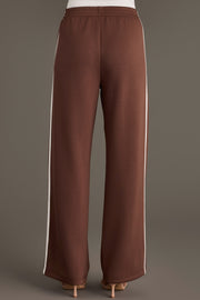 Back view of Brown Lounge Sweatpants in brown with a wide-leg fit and a white vertical stripe along each side.