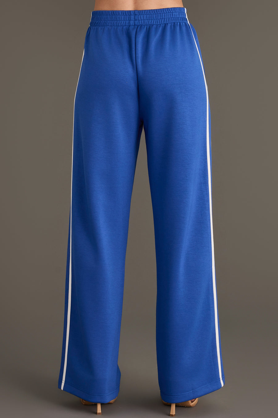 Blue Lounge Sweatpants featuring a wide-leg design with a white side stripe and an elastic waist.