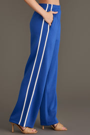 Blue Lounge Sweatpants in bright blue, featuring a wide-leg fit and two vertical white stripes down the outer seams.