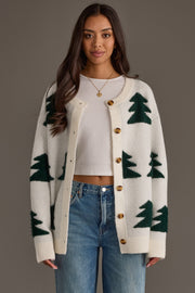 A woman wears a White Button Up Tree Cardigan from the Panache Apparel Collection over a white crop top and blue jeans.