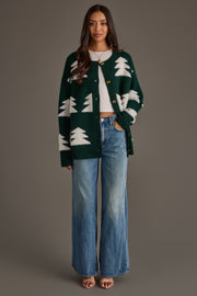 A woman wears a Green Button Up Tree Cardigan from the Panache Apparel Collection over a white shirt with wide-leg blue jeans.