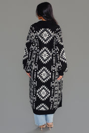 Back view of Panache Apparel’s black and white Western cardigan showcasing the oversized geometric pattern and longline silhouette.