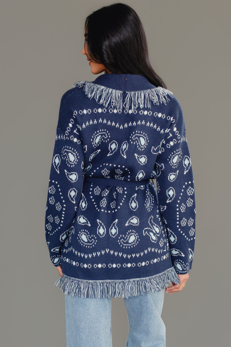 Back view of Panache Apparel’s blue bandana fringe cardigan showing the bandana pattern and fringe trim.
