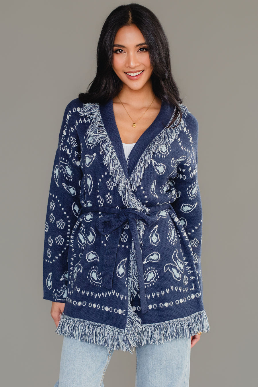 Front studio shot of Panache Apparel’s blue bandana fringe cardigan tied at the waist.