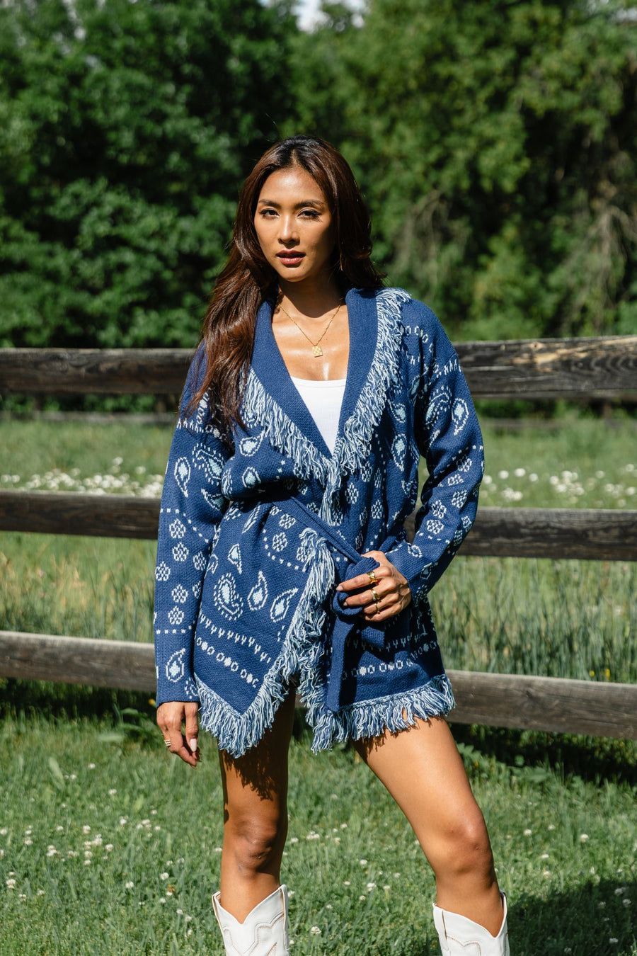 Woman wearing Panache Apparel’s blue bandana fringe cardigan outdoors, front view.