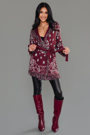 Full-length studio image of Panache Apparel’s burgundy bandana fringe cardigan with matching burgundy boots.