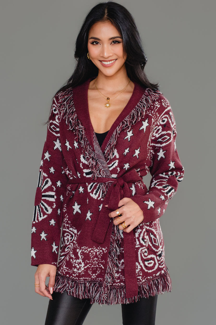 Front studio shot of Panache Apparel’s burgundy bandana fringe cardigan with fringe trim and tie belt.