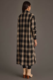 A woman stands with her back to the camera against a plain gray background, wearing the Panache Apparel Collection Black & Tan Plaid Long Lightweight Jacket, paired with black pants and tan heeled boots.