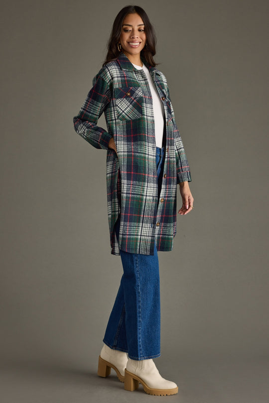 Side view of Manchester Plaid Long Flannel featuring a green, gray, and red plaid pattern with relaxed longline fit.