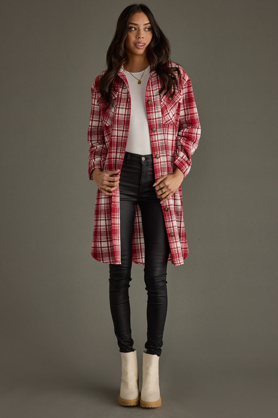 Full-body view of Winston Plaid Long Flannel styled open with black pants and boots.