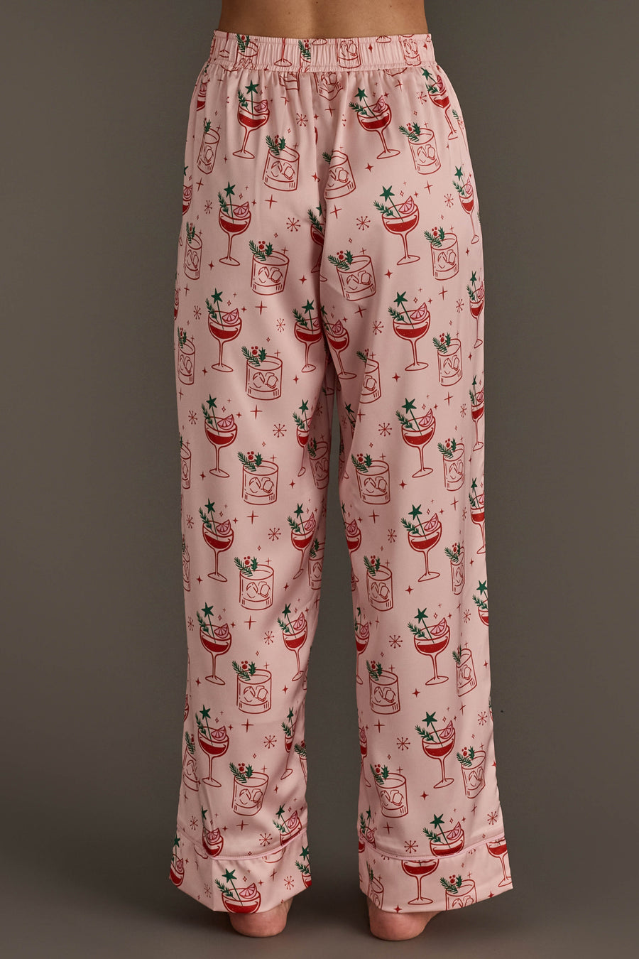 Light Pink Christmas Cocktails Satin Pajama Set pants in light pink satin, patterned with illustrated Christmas cocktails and small stars.