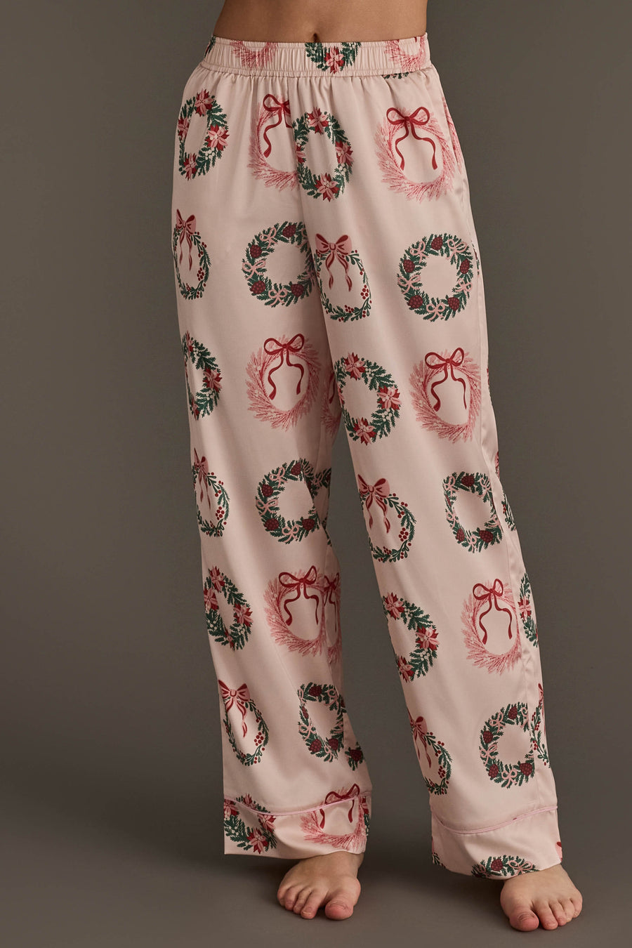 Light pink Christmas Wreaths Satin Pajama Set featuring an all-over print of Christmas wreaths with red bows.