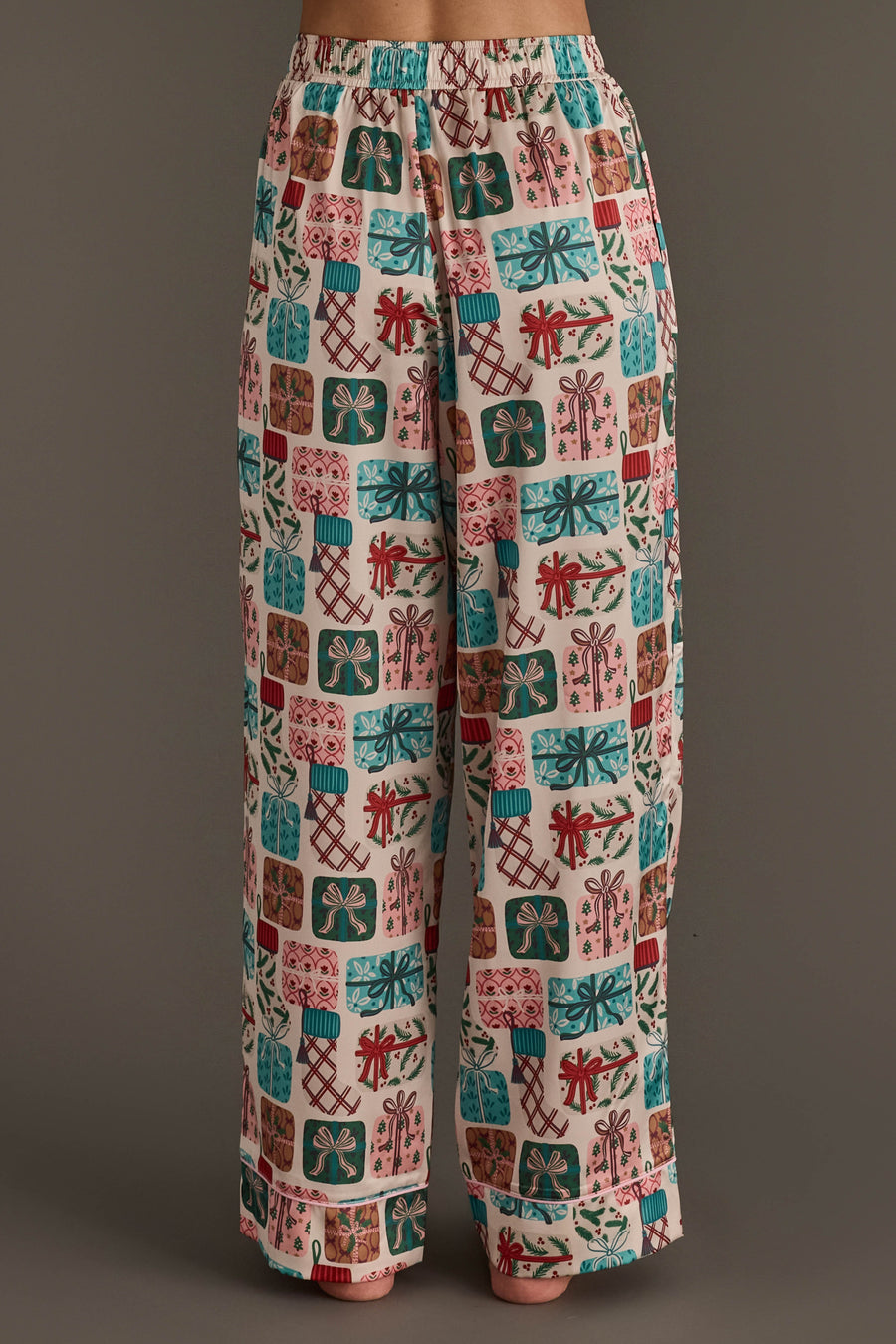 Wide-leg festive holiday pajama pants from the Christmas Presents Satin Pajama Set featuring a repeating pattern of colorful Christmas gift boxes with bows.